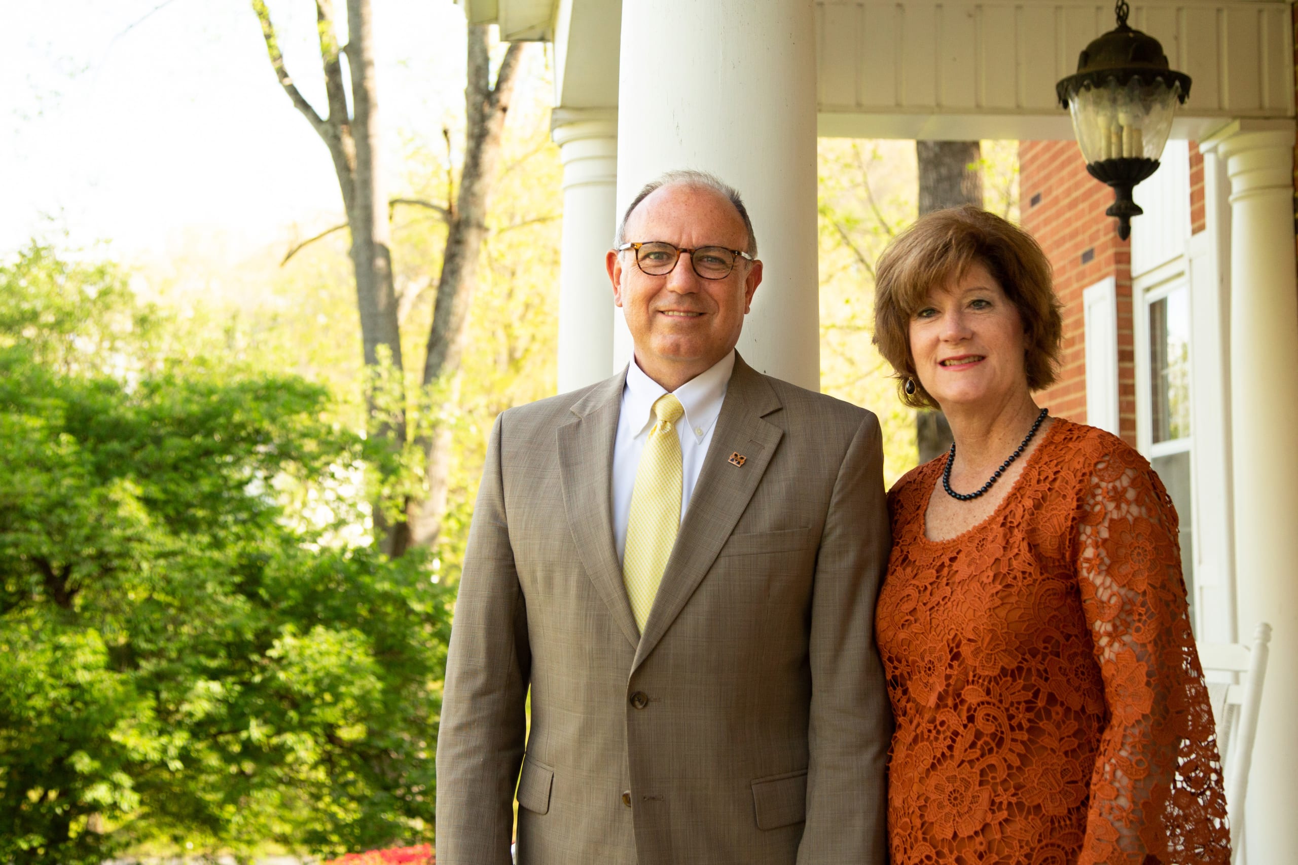 President and First Lady Bill and Edwina Greer in front of Milligan University's Little Hartland Welcome Center.